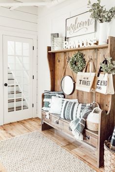 a wooden bench sitting in the middle of a living room next to a white door