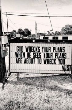 black and white photograph of a sign that says god wrecks your plans when he sees your plans are about to wreck you