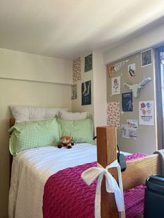 a cat laying on top of a bed in a bedroom