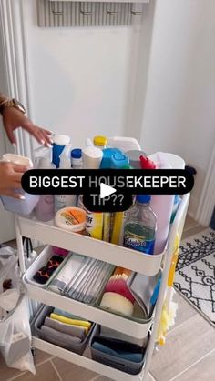 a woman is holding onto the bottom shelf of a cart filled with cleaning products and other items