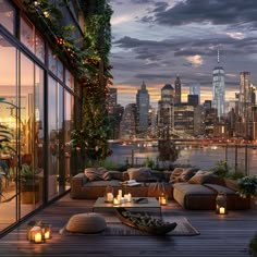 an outdoor living area with couches, tables and candles on the deck in front of a cityscape