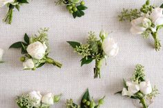 white flowers are arranged on a table cloth