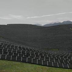 a large amount of solar panels are arranged in the shape of mountains and hills on a cloudy day