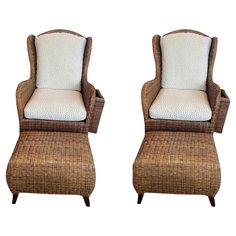 two wicker chairs with white cushions and footstools