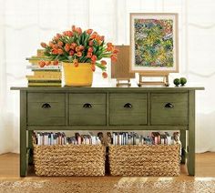 a green dresser with baskets and flowers on top