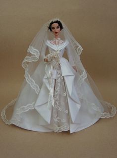 a doll dressed in a wedding gown and veil