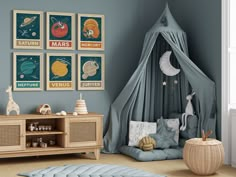 a baby's room with blue walls and pictures on the wall