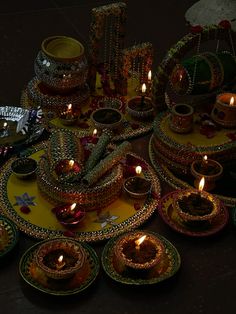 a table topped with lots of plates covered in candles