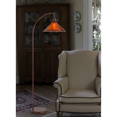 a living room with a chair and lamp in it