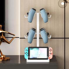 a nintendo wii game system sitting on top of a table next to a gold statue