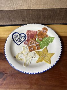 a white plate topped with cut out gingerbreads and star cookies on top of a wooden table