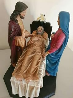 a statue of jesus in the manger with two women