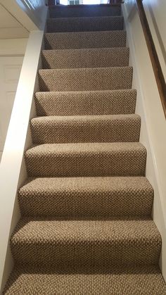 a carpeted staircase leading up to an open door