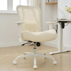 a white office chair sitting on top of a hard wood floor