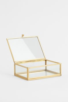 an open glass box with a chain hanging from the front and bottom, on a white background