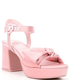 From GB&#x2C; the Girls' Sadie Satin Half Bow Family Matching Dress Sandals feature:Satin upperAnkle strap closureSynthetic liningCushioned footbedRubber outsoleApprox. 1.6" platform heightApprox. 2.6" heel heightImported. Baby Pink Heels With Bow, Pink Block Heel Heels With Bow, Pink Ankle Strap Sandals With Bow, Pink Kid Heels, High Heels For Kids, Pink High Heel Sandals With 4-inch Heel, Girls Dress Shoes, Pink High Heels, Classic Wardrobe Staples