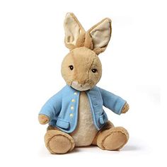 a small stuffed rabbit wearing a blue jacket