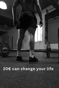 a man standing in the middle of a gym with his legs crossed and no shirt on