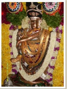 the statue is surrounded by flowers and garlands