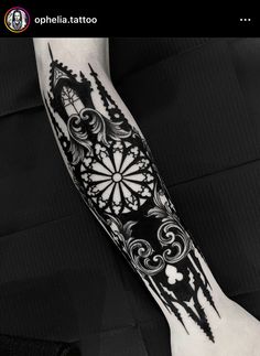 a black and white tattoo design on the arm