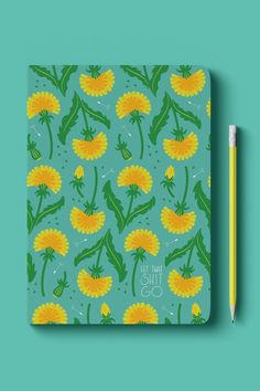 a notebook with yellow dandelions on it and a green pen next to it