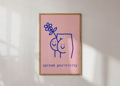 a pink poster hanging on the side of a wall next to a wooden framed object