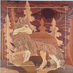 a wood carving of a wolf with trees in the background