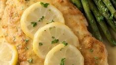 chicken with lemons and asparagus on a plate