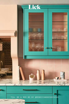 a kitchen with blue cabinets and marble counter tops, including the words click on it