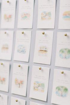 many small cards are pinned to the wall