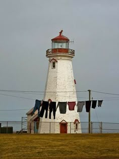 clothes hanging out to dry in front of a light house