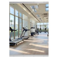 there are many treadmills in the gym with large windows on either side of them