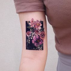 a woman with a flower tattoo on her arm