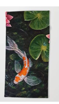 an orange and white koi fish swimming in water with lily pads