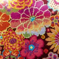 a close up view of a colorful flowered fabric with lots of flowers on it