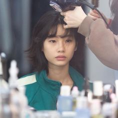 a woman is getting her hair done at the salon