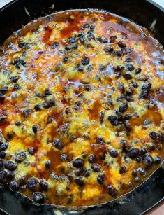 a skillet filled with black olives and cheese