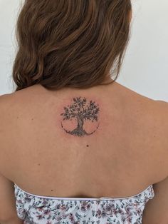 a woman with a tree tattoo on her back