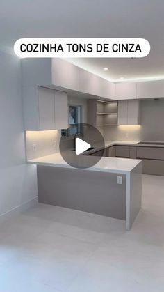 an empty kitchen with white walls and cabinets in the center, is featured on a video screen