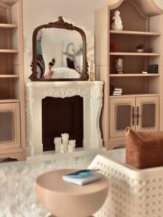 a living room filled with furniture and a large mirror on top of a fireplace mantel