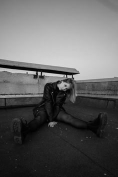 a woman sitting on the ground with her legs crossed