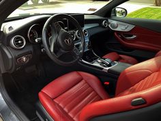 the interior of a car with red leather seats