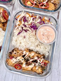 four plastic containers filled with food on top of a white wooden table next to rice and sauce