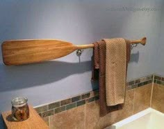 a bath room with a wooden paddle on the wall