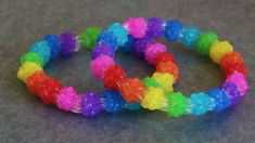 three different colored bracelets sitting on top of a table