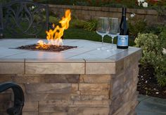 a fire pit with two wine glasses on it