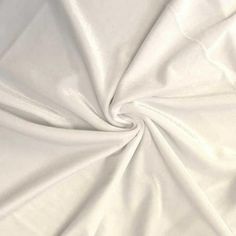 Stretch velvet fabric is a 4-way stretch fabric with a smooth back and textured polyester velvet front. This fabric is extremely soft with a beautiful sheen. This is a medium weight fabric of 253 gsm (approx.) with a 90% polyester 10% spandex content and 58/60" width. The polyester content makes it ideal for washing. This fabric is great for apparel, costumes, dance wear, decorations and more. The velvet has a soft texture, drapes very well with hemmed edges. Its wide width also makes it an idea Crushed Velvet Fabric, Fabric For Sewing, Velvet Shirt, White Velvet, Stretch Velvet, 4 Way Stretch Fabric, Crushed Velvet, Velvet Fabric, Dance Wear