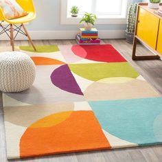 a brightly colored area rug in a living room