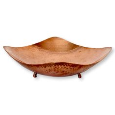 a large metal bowl sitting on top of a wooden stand