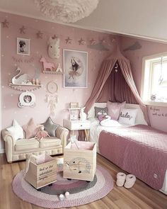 a bedroom with pink walls and white furniture